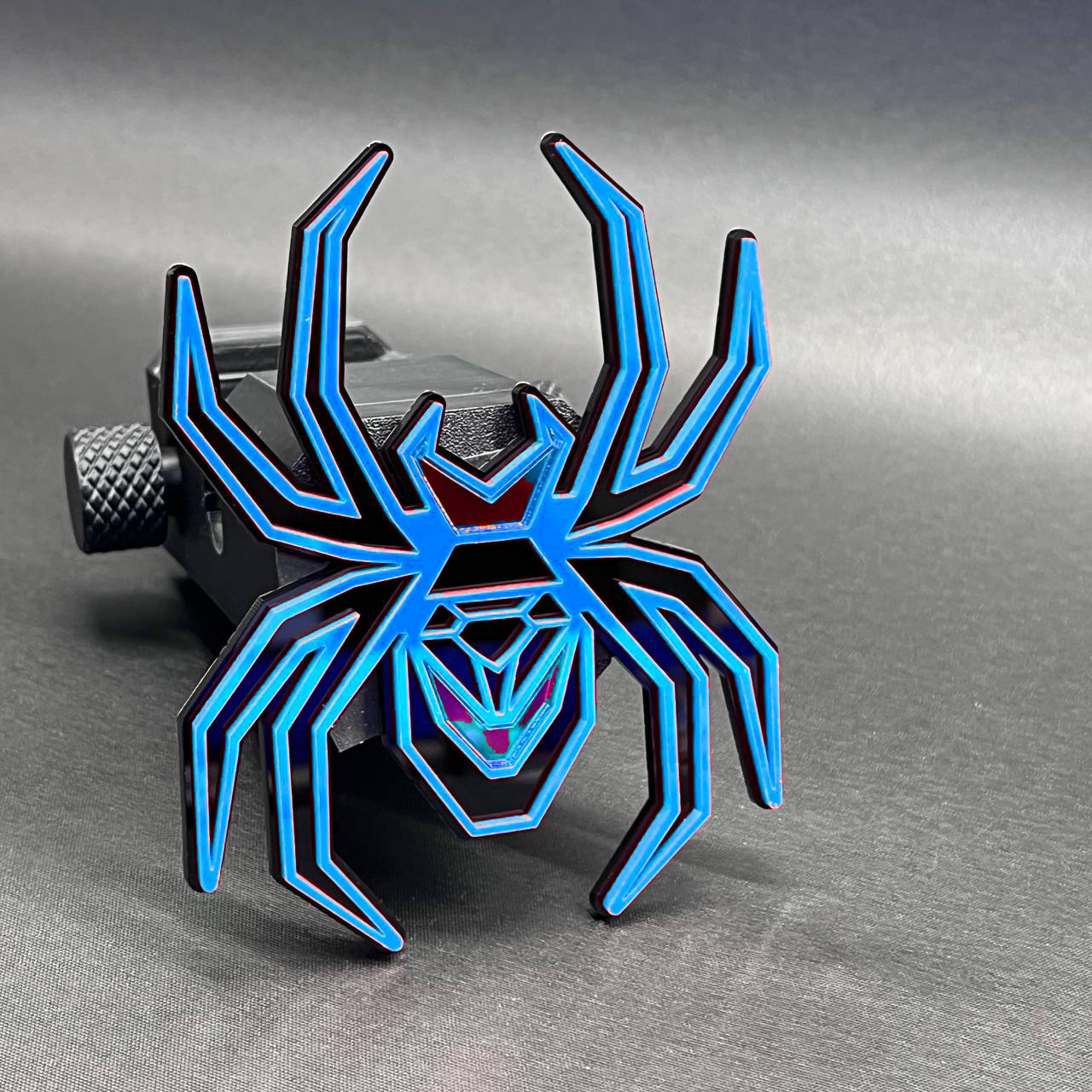 Stylish Black Widow hitch cover badge with layered mirror acrylic spider design.