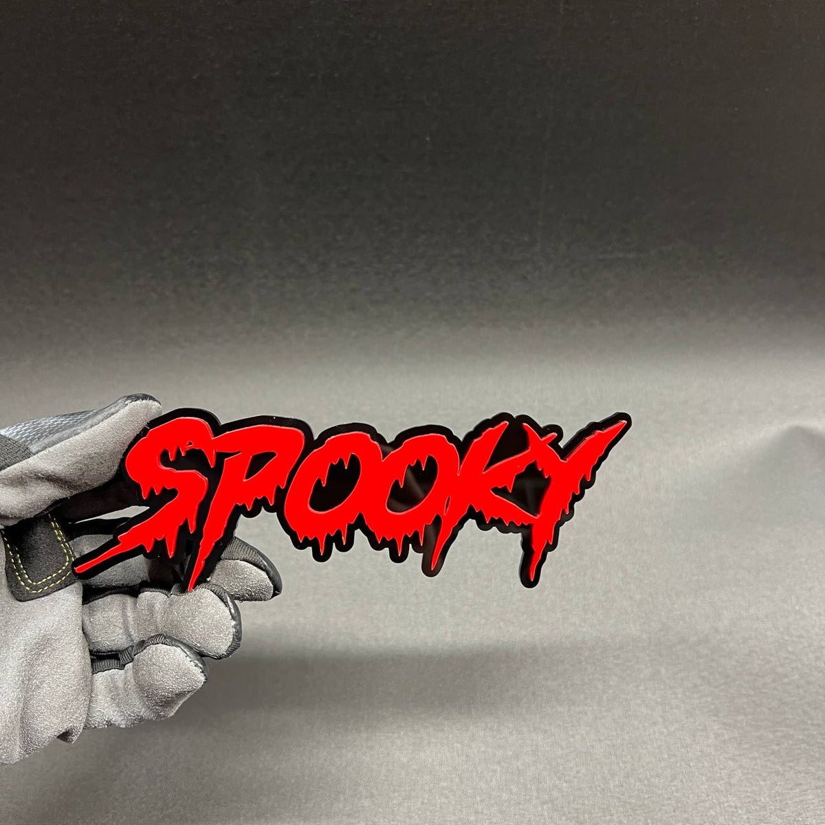 Spooky text emblem car badge for truck SUV or custom vehicle with red lettering and black layered design