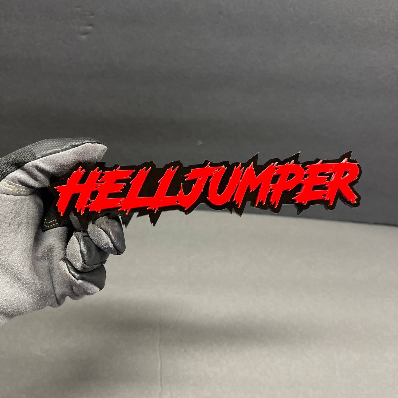 Hell Jumper red acrylic auto decal badge with black shadow backing for performance inspired custom vehicle look.