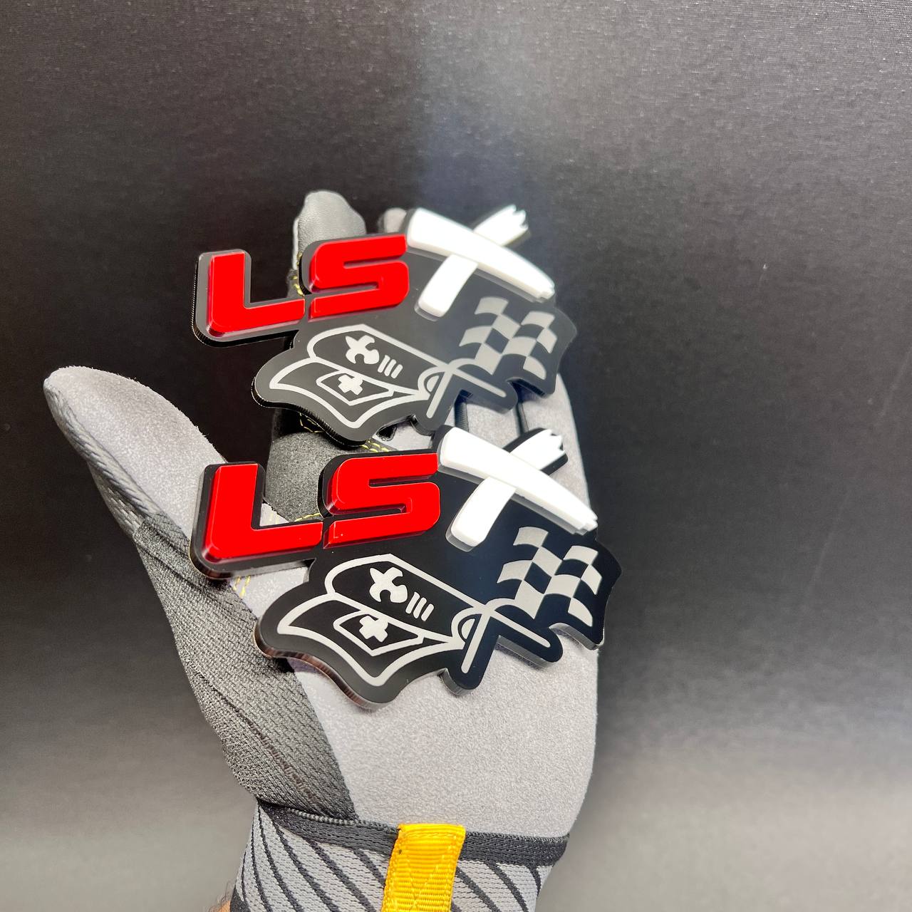 Custom LSX racing flag exterior emblem displayed on a work glove