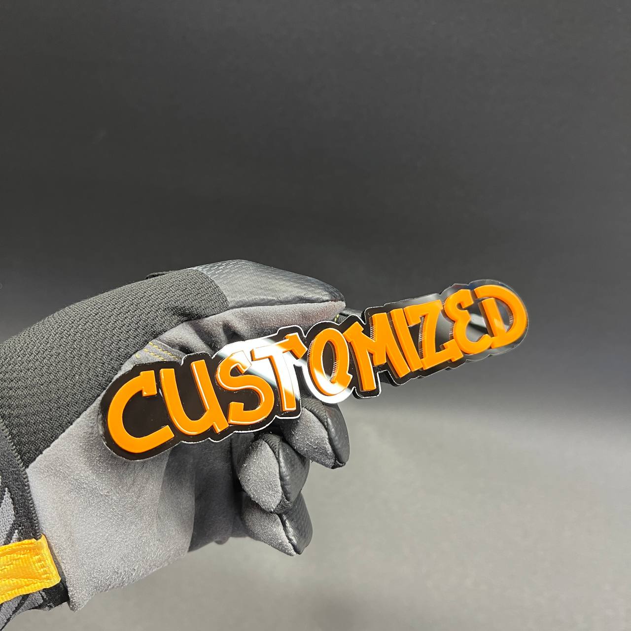 Orange lettering graffiti badge on black base for custom vehicle styling