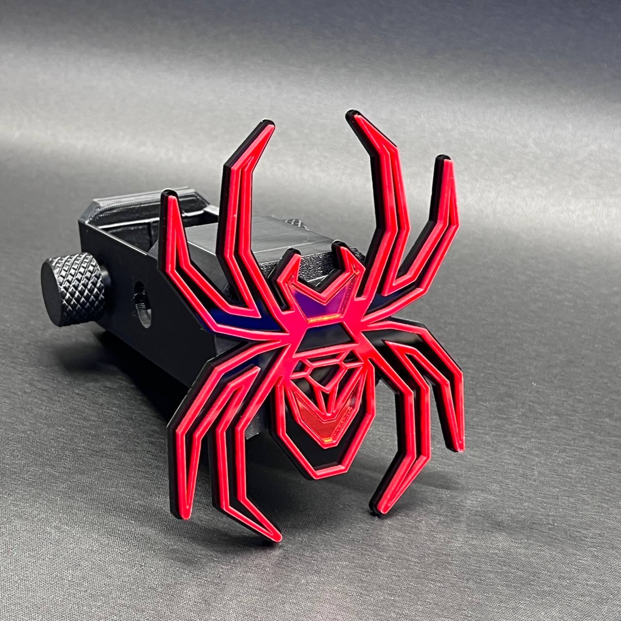 Stylish Black Widow hitch cover badge with layered mirror acrylic spider design.