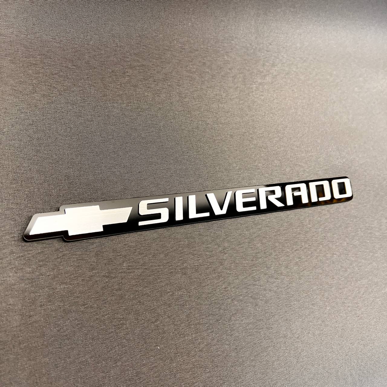 Black and silver Chevy Silverado bowtie tailgate badge for truck exterior customization