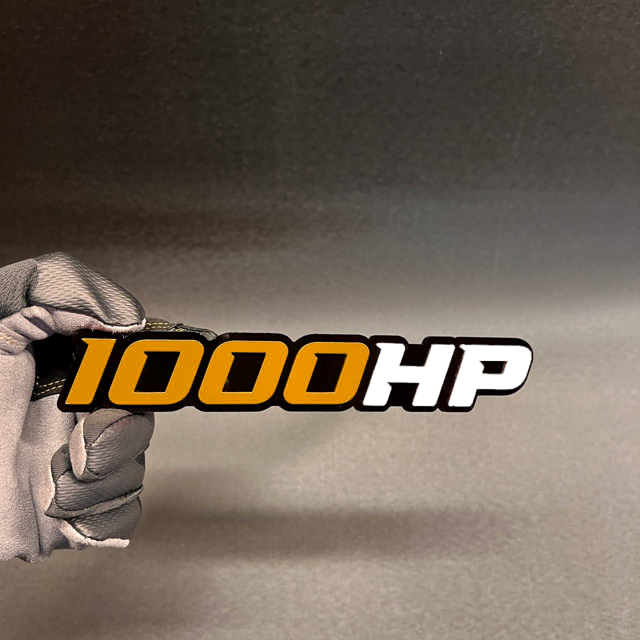 Handcrafted 1000HP badge for cars and trucks with black base
