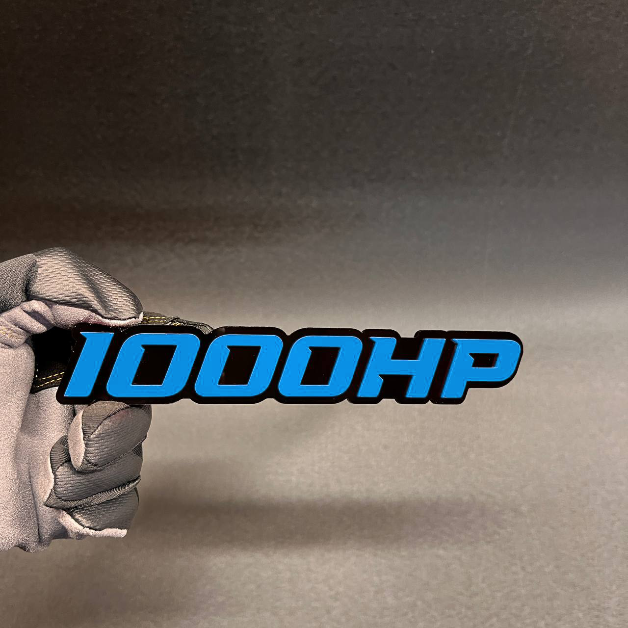 Handcrafted 1000HP horsepower badge with red top layer and black base