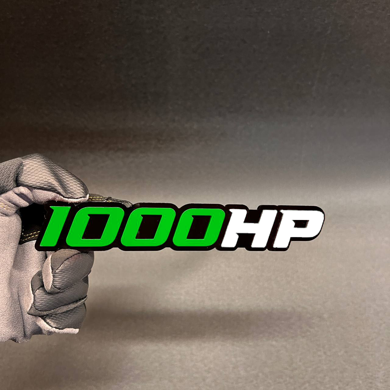 Red and white 1000HP car badge with bold black outline