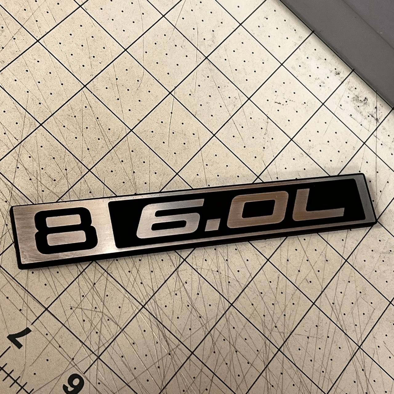 Classic Chevy C10 6.0L truck emblem in silver billet and black design.
