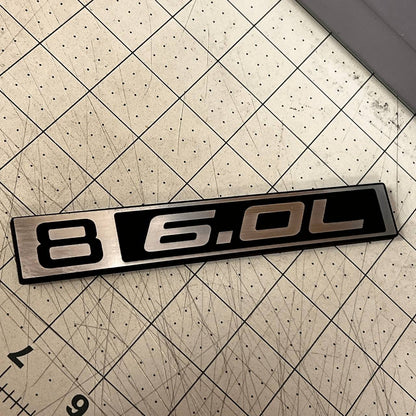 Classic Chevy C10 6.0L truck emblem in silver billet and black design.