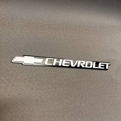Chevrolet silver logo tailgate emblem compatible with 1999-2006 Chevy vehicles.