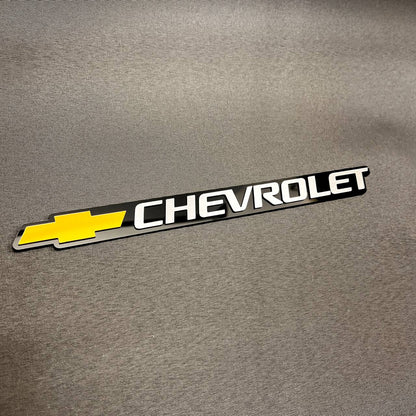 Replacement Chevy gold Bowtie and silver Chevrolet tailgate emblem compatible with 1999-2006 Chevrolet vehicles.