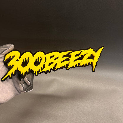 300 Beezy custom yellow and black drip style car badge with 3D layered design.