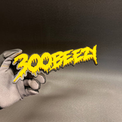 Yellow 300 Beezy drip font exterior car emblem for custom vehicle styling.