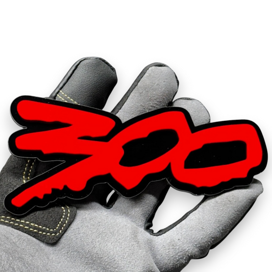 Glossy black 300 logo car emblem close-up