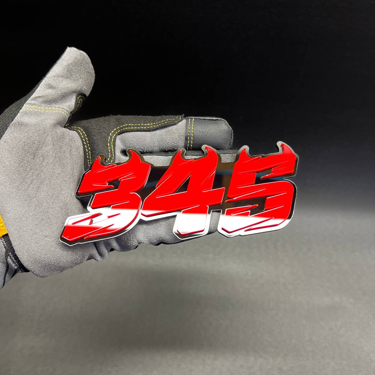 345 badge shown as custom vehicle fender emblem with aggressive horned design