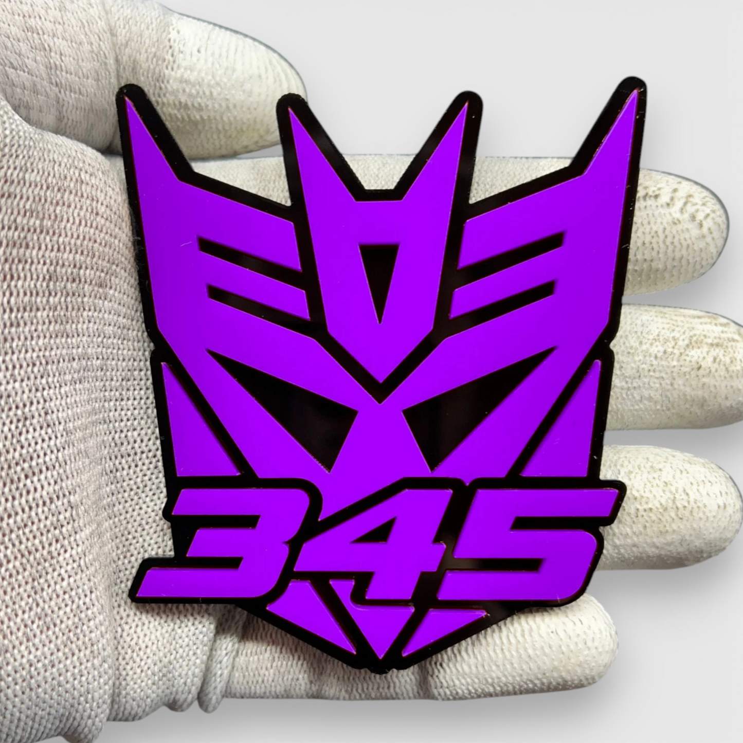 Transformer style 345 robot mask emblem with black background