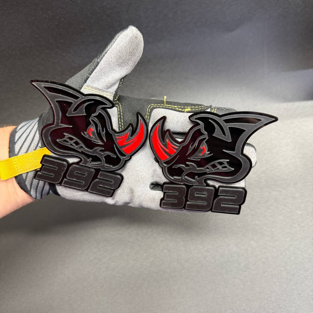 392 HEMI Rhino automotive emblem featuring black-on-black rhinoceros details, contrasting red horns and bold 392 lettering for custom muscle car styling.