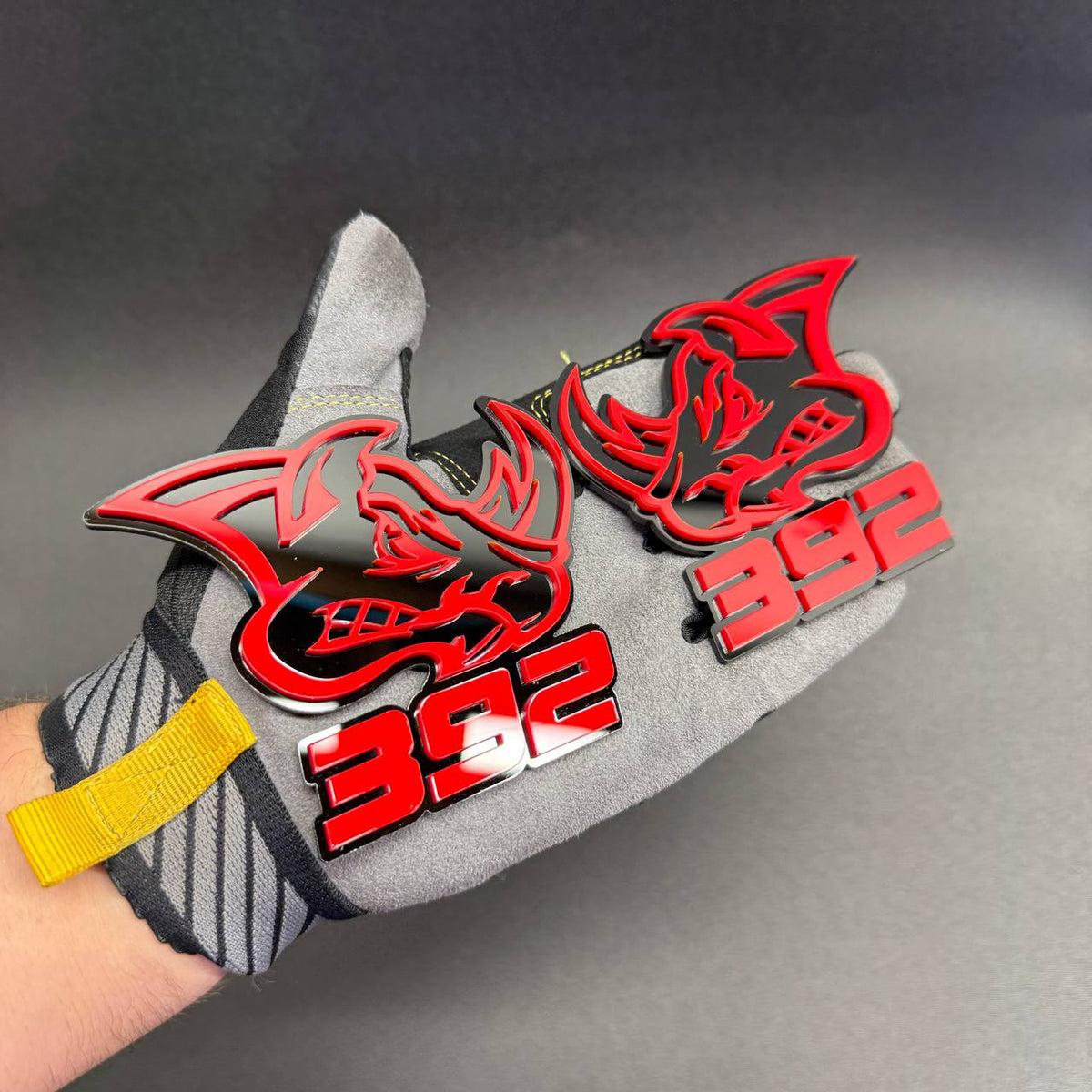 392 HEMI Rhino automotive emblem featuring aggressive rhinoceros head, contrasting red and black acrylic layers and bold 392 engine displacement lettering.