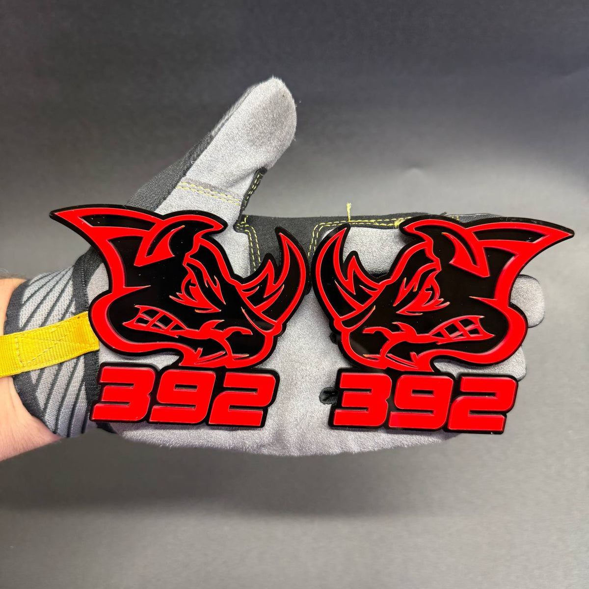 Custom Mopar 392 Rhino car badge with aggressive rhinoceros artwork, red acrylic lettering and black layered base for HEMI V8 muscle car exterior styling.