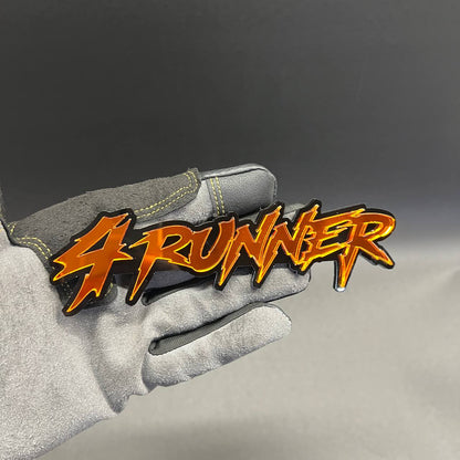 Custom 4RUNNER text car badge in glossy orange with black outline