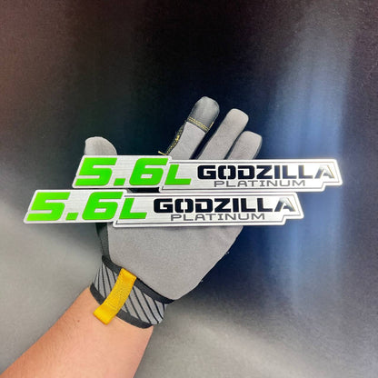 5.6L Godzilla Platinum car badge with bright green lettering and brushed silver background