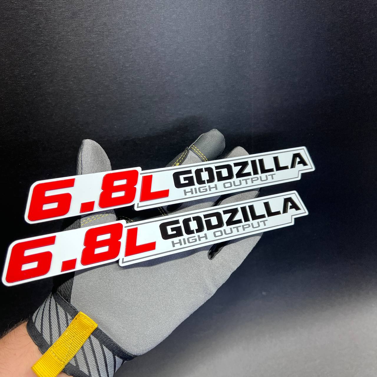 6.8L Godzilla High Output car badge with red, black, silver and white layered design
