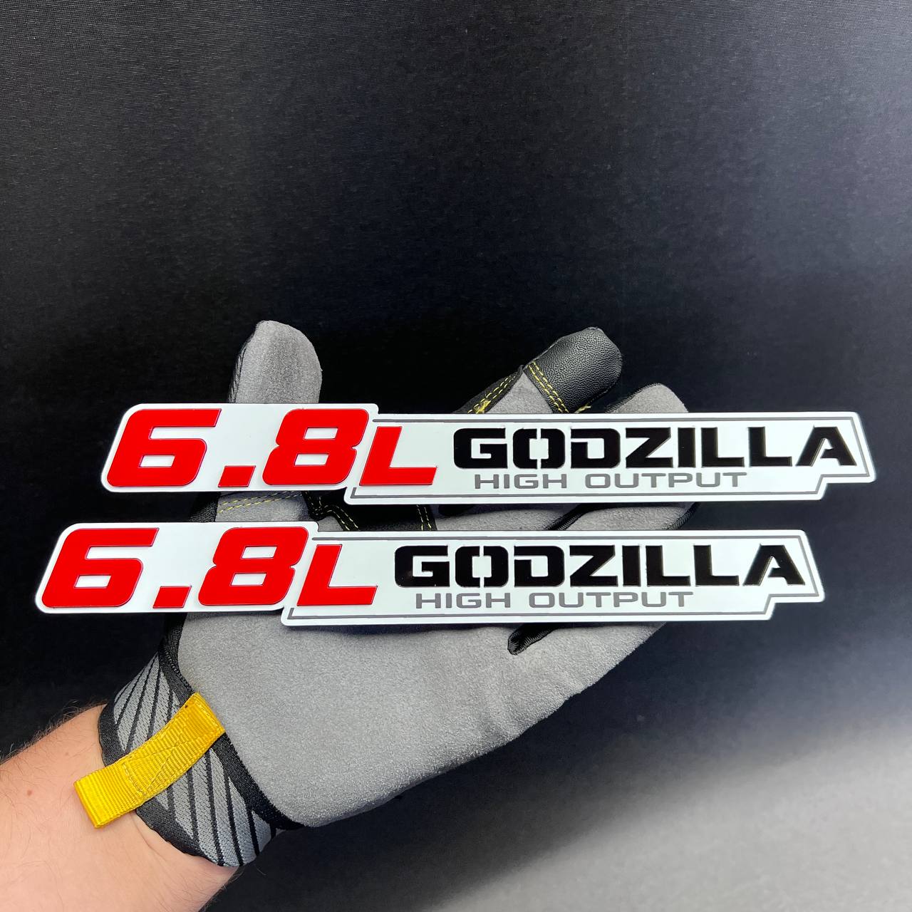 Red and silver 6.8L Godzilla High Output fender badge with black lettering