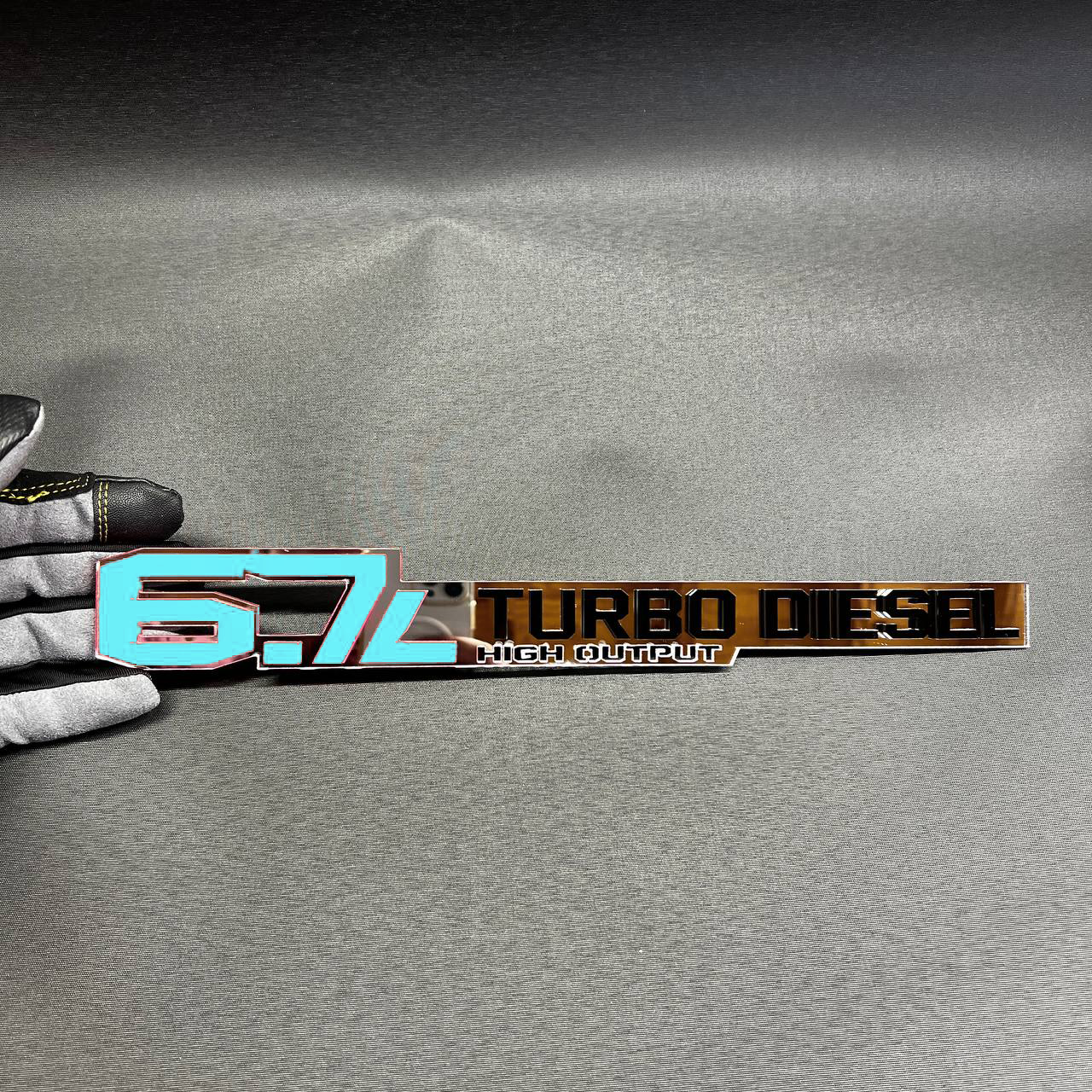 6.7L Cummins High Output acrylic emblem for heavy duty truck exterior upgrade.