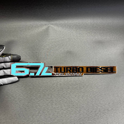 6.7L Cummins High Output acrylic emblem for heavy duty truck exterior upgrade.