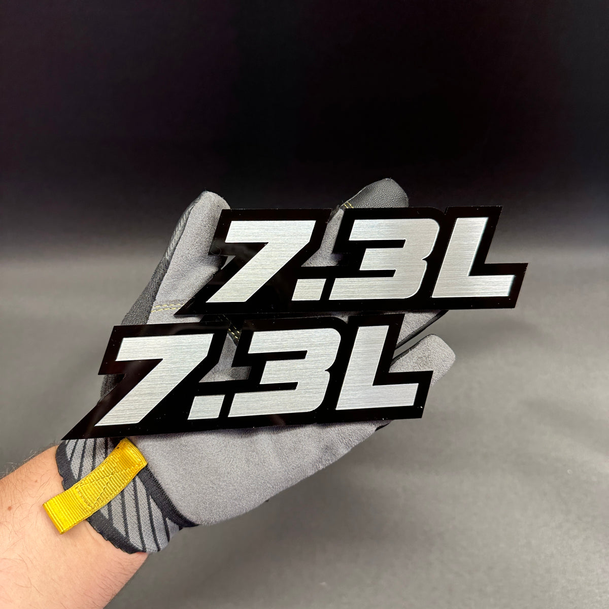 7.3L V8 truck badge with silver design and black background for Ford Super Duty