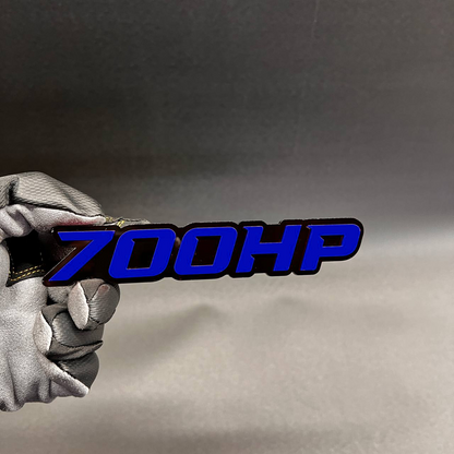 Handcrafted 700HP horsepower badge with red top layer and black base