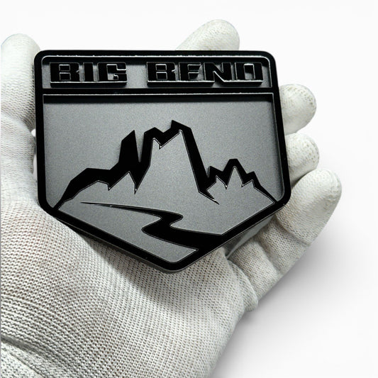 Matte and gloss black acrylic mountain badge detail with layered 3D design