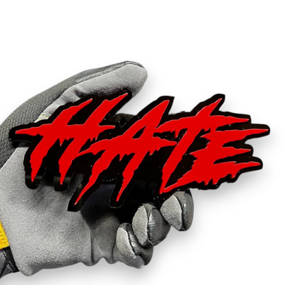 Red and black HATE text badge made from layered acrylic for custom car styling.