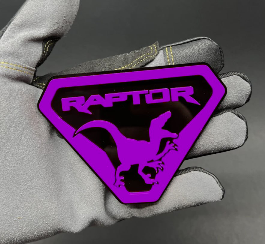 Close up of laser cut acrylic raptor badge detail