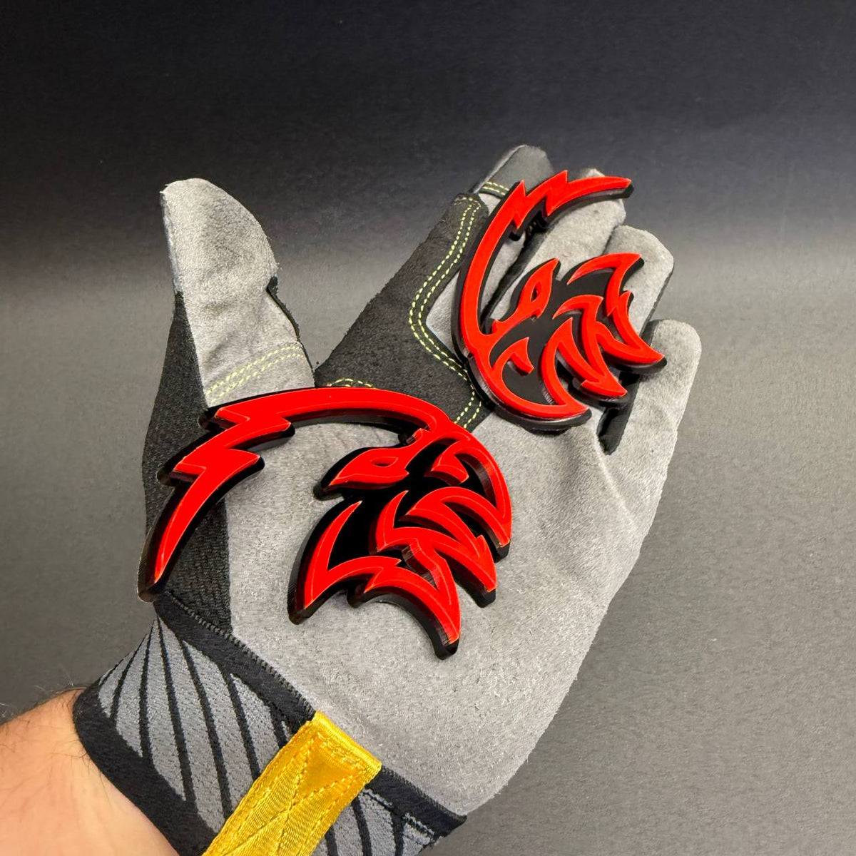 Angry Falcon red and black aftermarket fender emblem with sharp bird head graphics for Dodge Charger, Challenger and RAM truck customization.