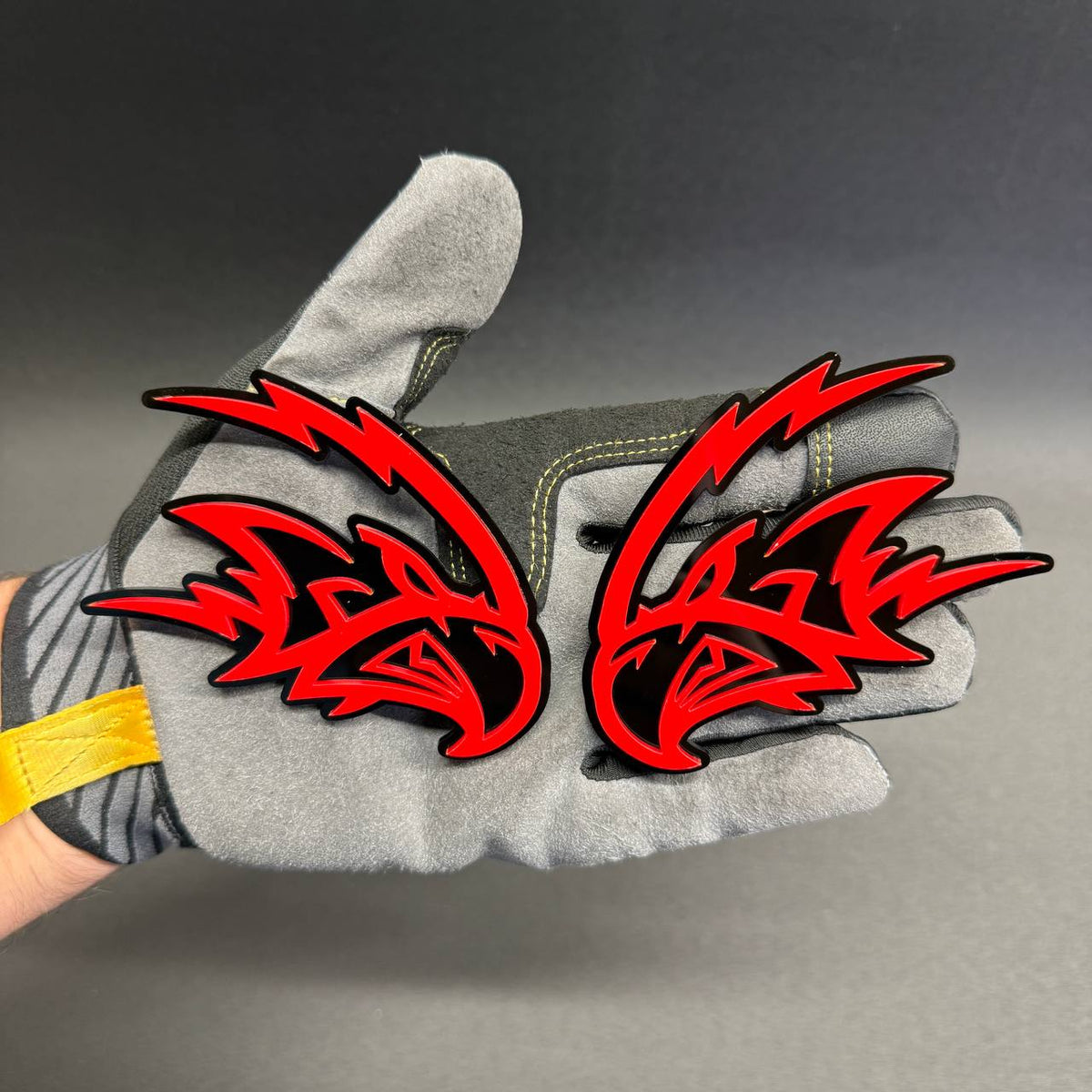 Custom Angry Falcon fender badge featuring a sharp red falcon head with black background for Ford, Dodge, RAM and Chevrolet vehicle customization.
