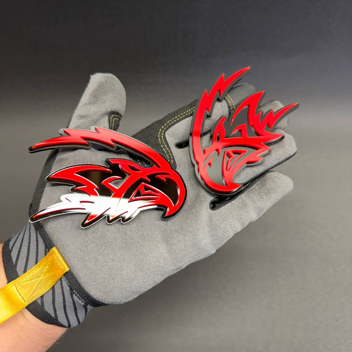 Pair of Angry Falcon automotive emblems in glossy red and black, ideal for Mustang, Camaro, Challenger, Charger and performance car styling.