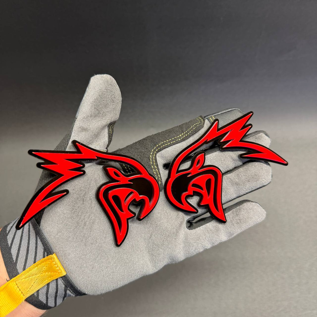 Angry Hawk red and black custom car badge featuring an aggressive bird head design for fender, grille or tailgate decoration.