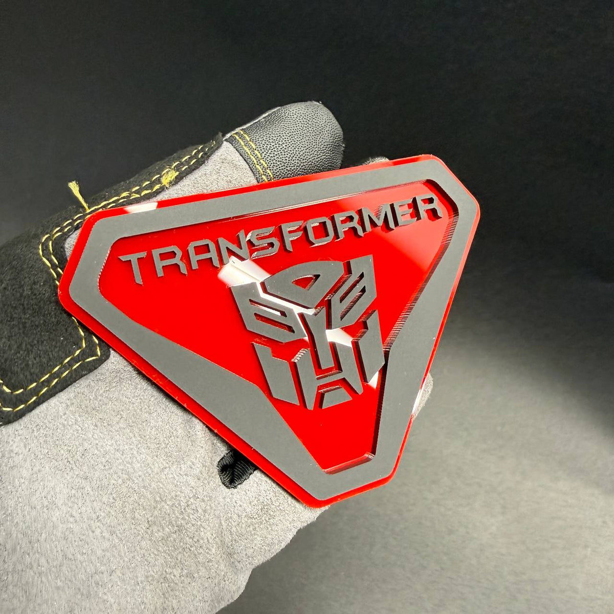 Custom Transformers Autobot shield car emblem with layered acrylic construction for personalized fender and tailgate decoration.