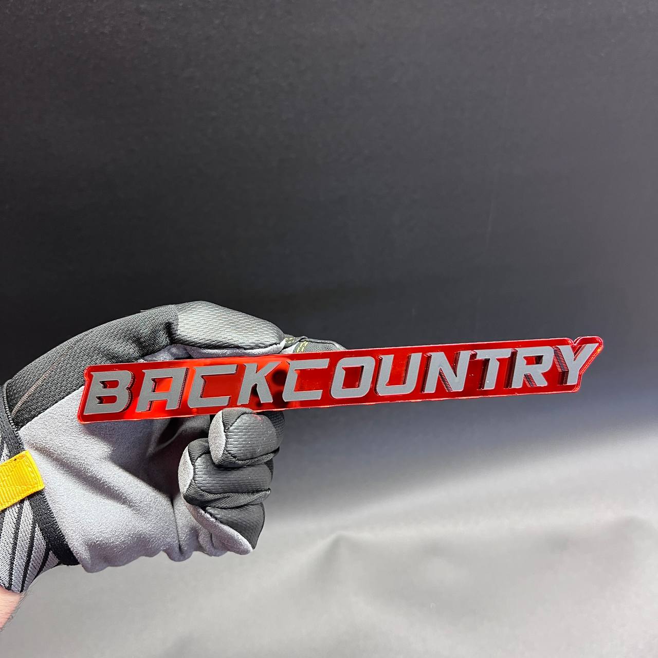 Back Country exterior car badge with bold raised lettering