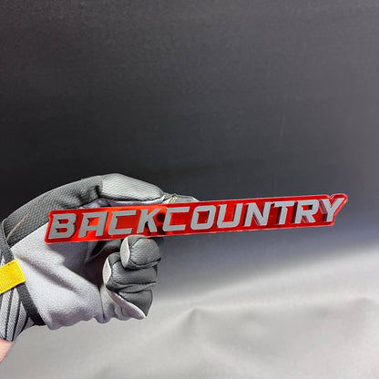 Back Country exterior car badge with bold raised lettering