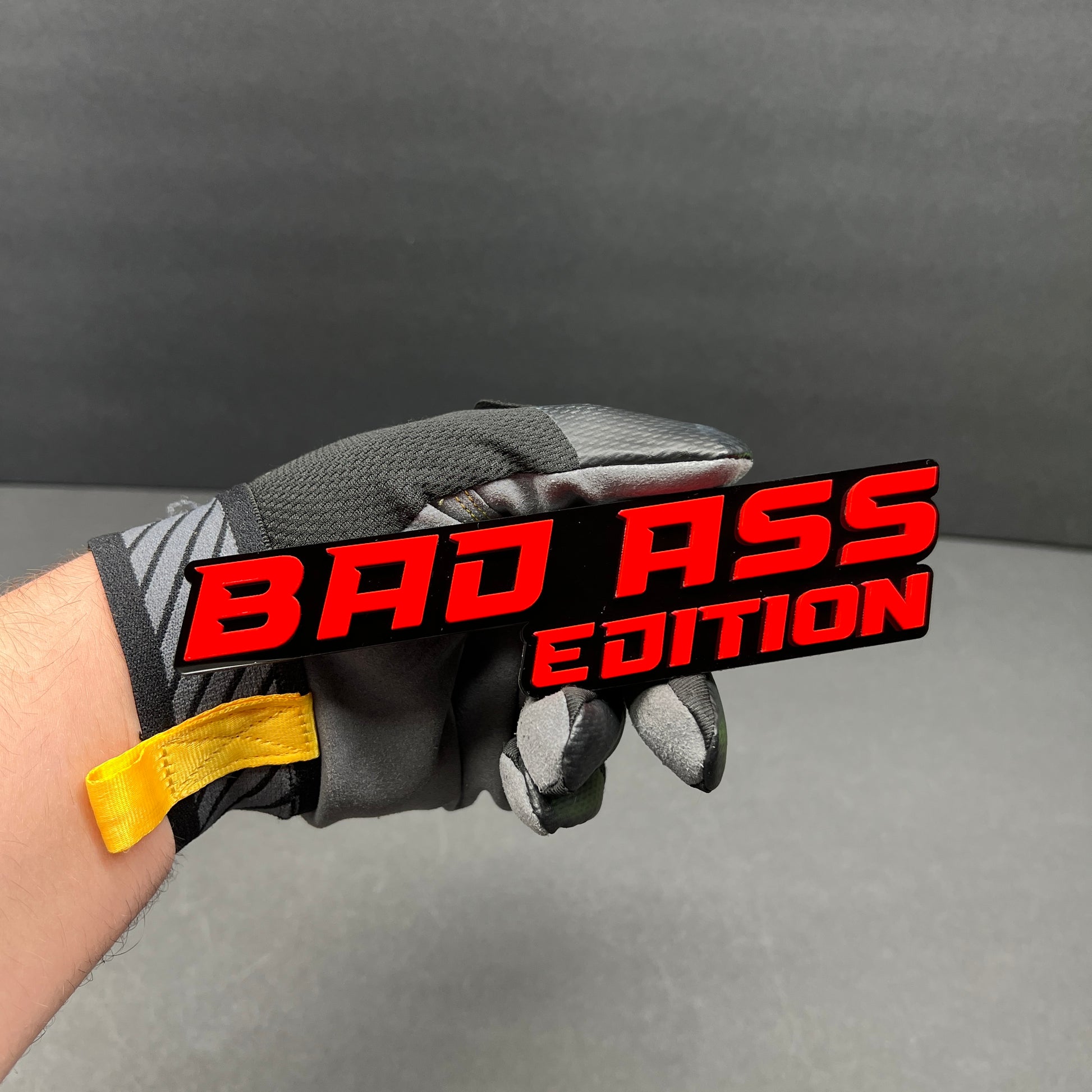 Custom Bad Ass Edition text badge with 3M adhesive for vehicle exterior installation.