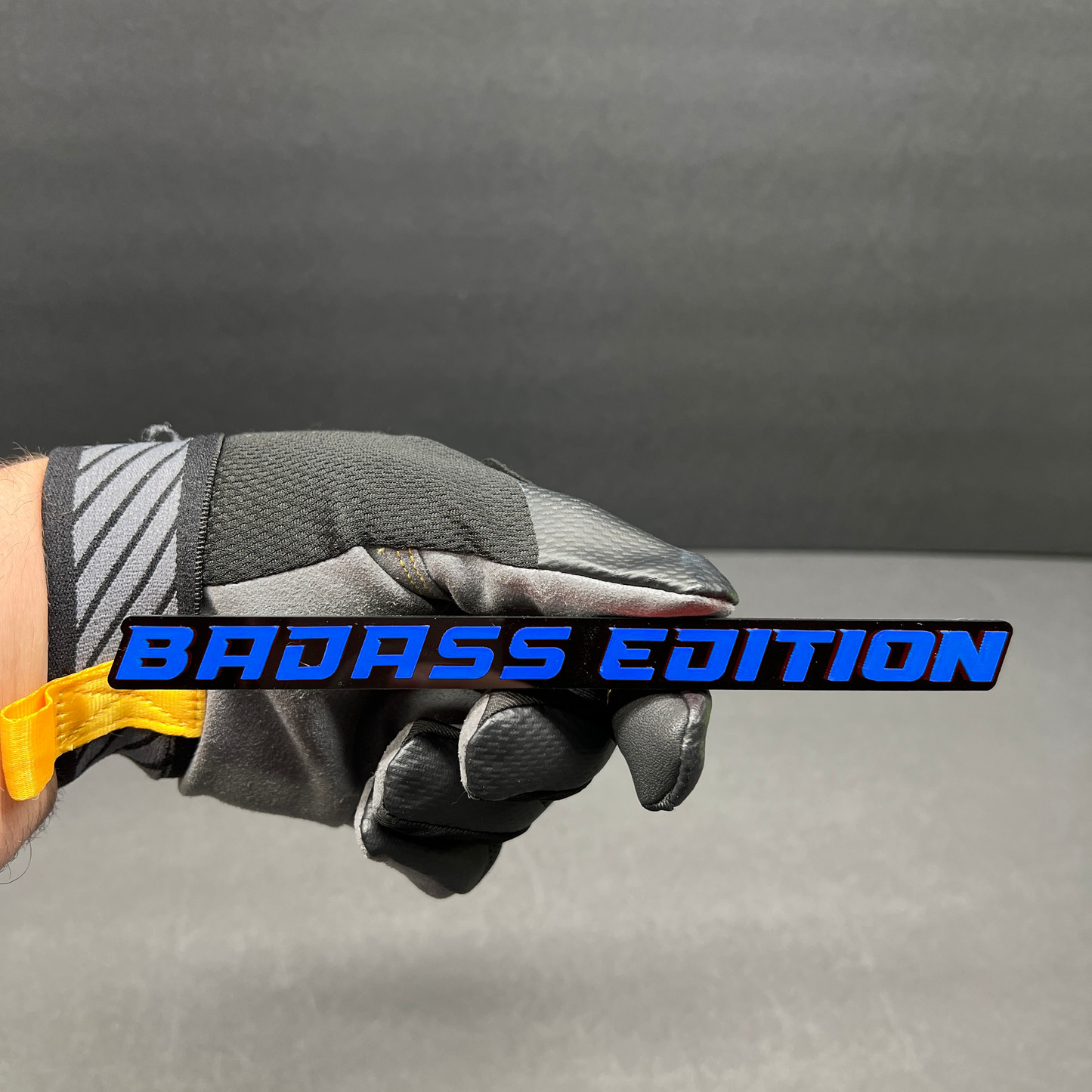 Gloss black Badass Edition text badge with white lettering for custom car or truck modification.