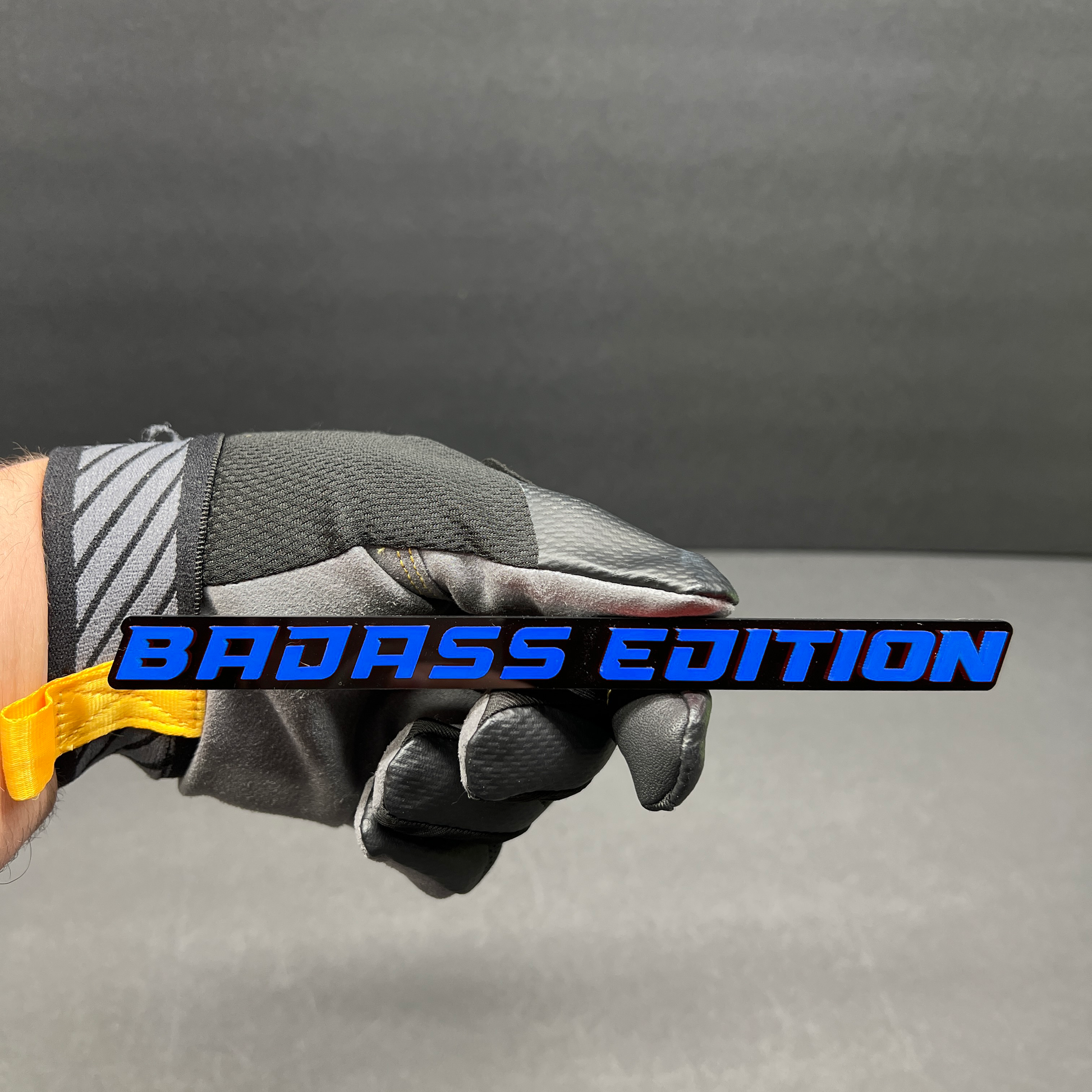 Gloss black Badass Edition text badge with white lettering for custom car or truck modification.