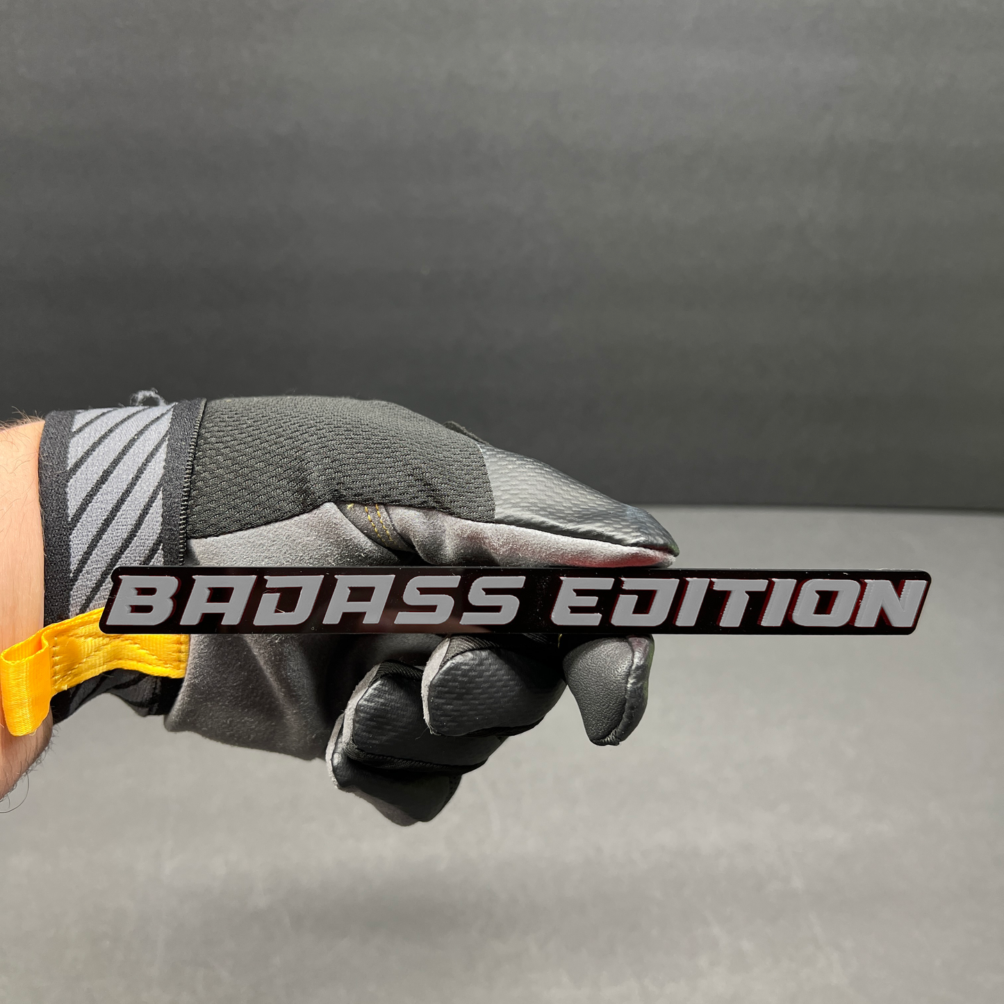 Black Badass Edition custom vehicle badge featuring bold performance-inspired lettering.