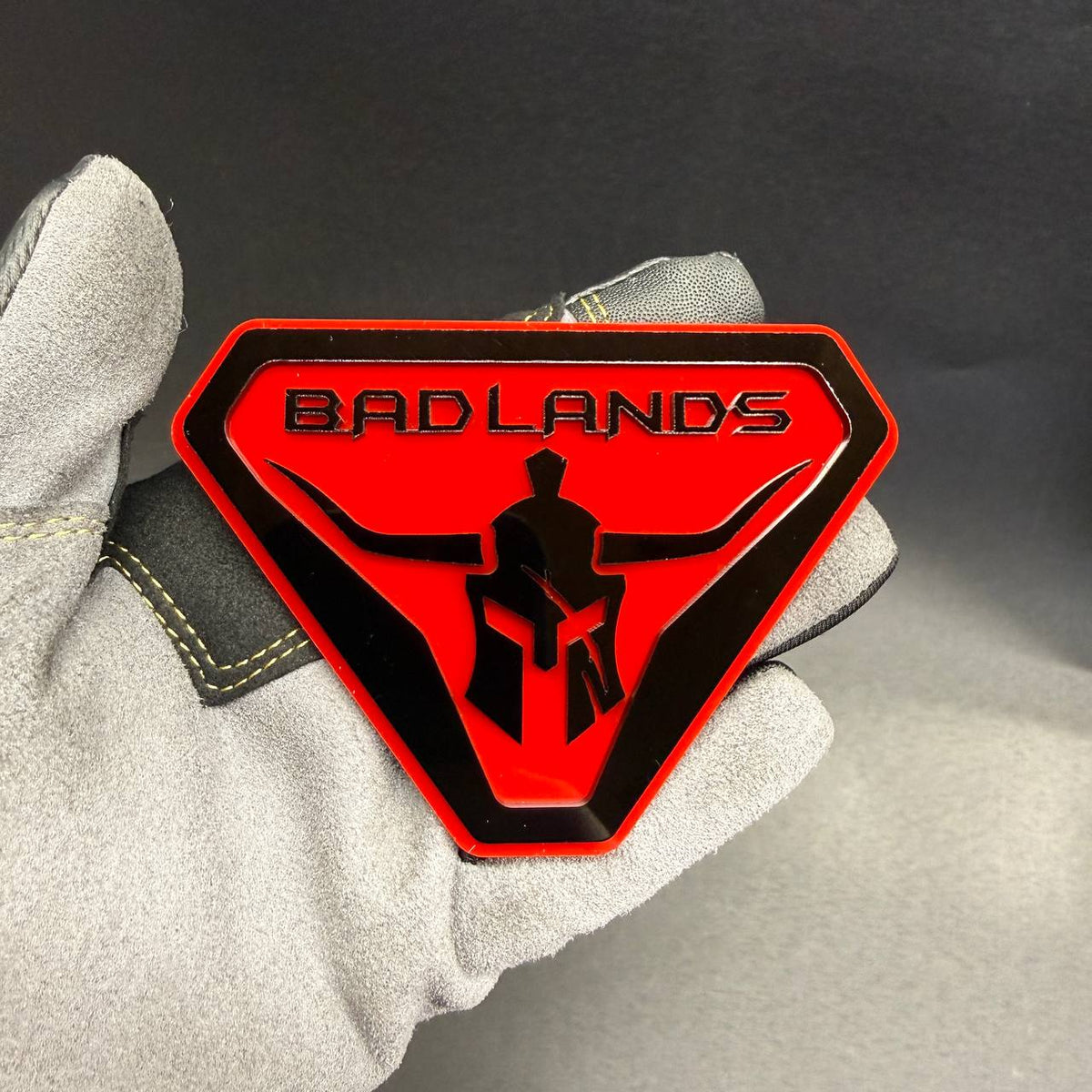 Badlands Gladiator car badge with Spartan warrior helmet design for off-road truck and SUV.