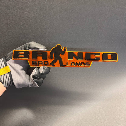 Badlands Sasquatch Peace car badge in black and orange finish