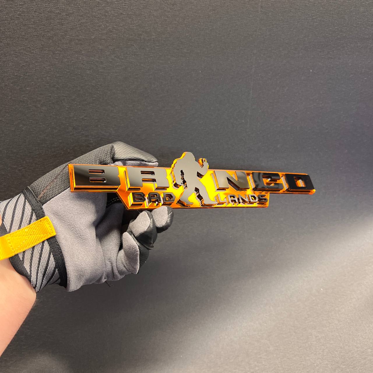 Black and orange Sasquatch Peace vehicle badge for fender or tailgate