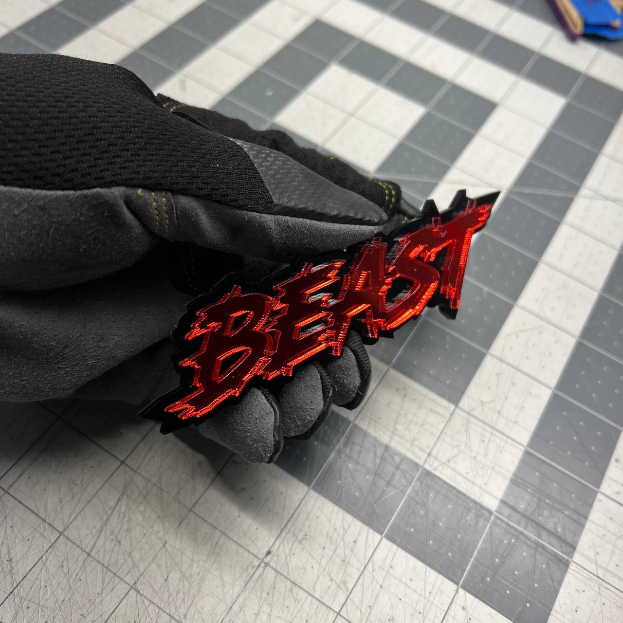 Red mirror BEAST automotive emblem mounted for muscle truck appearance