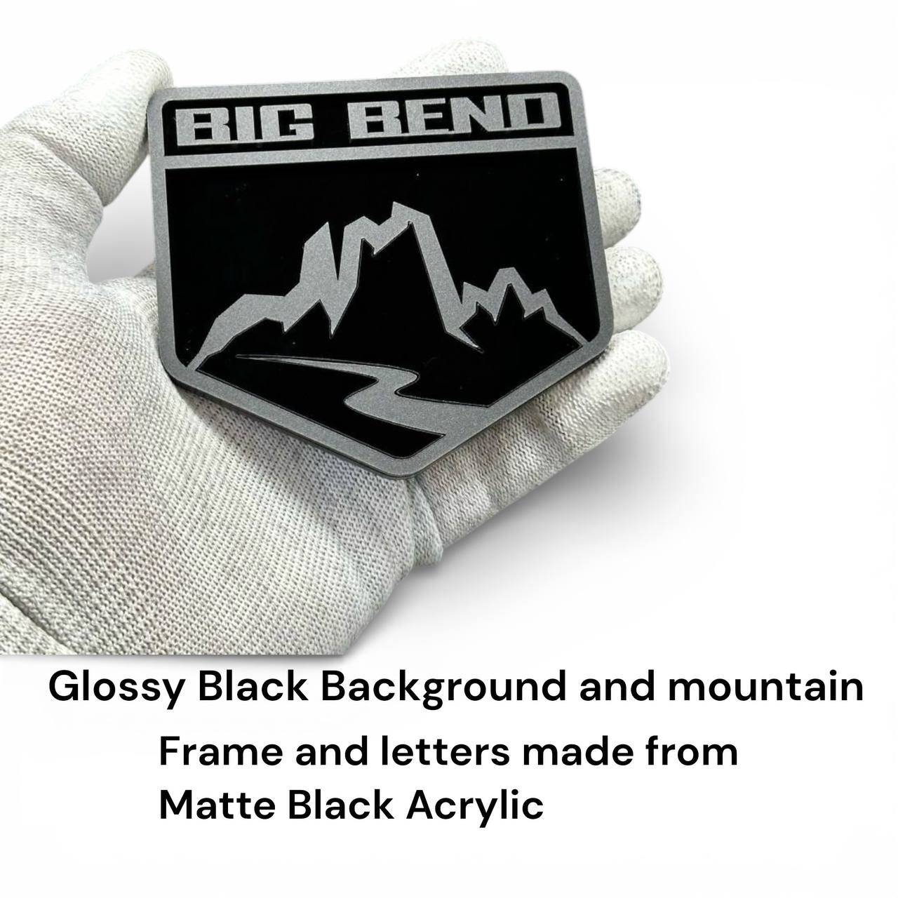 Matte and gloss black acrylic mountain badge detail with layered 3D design