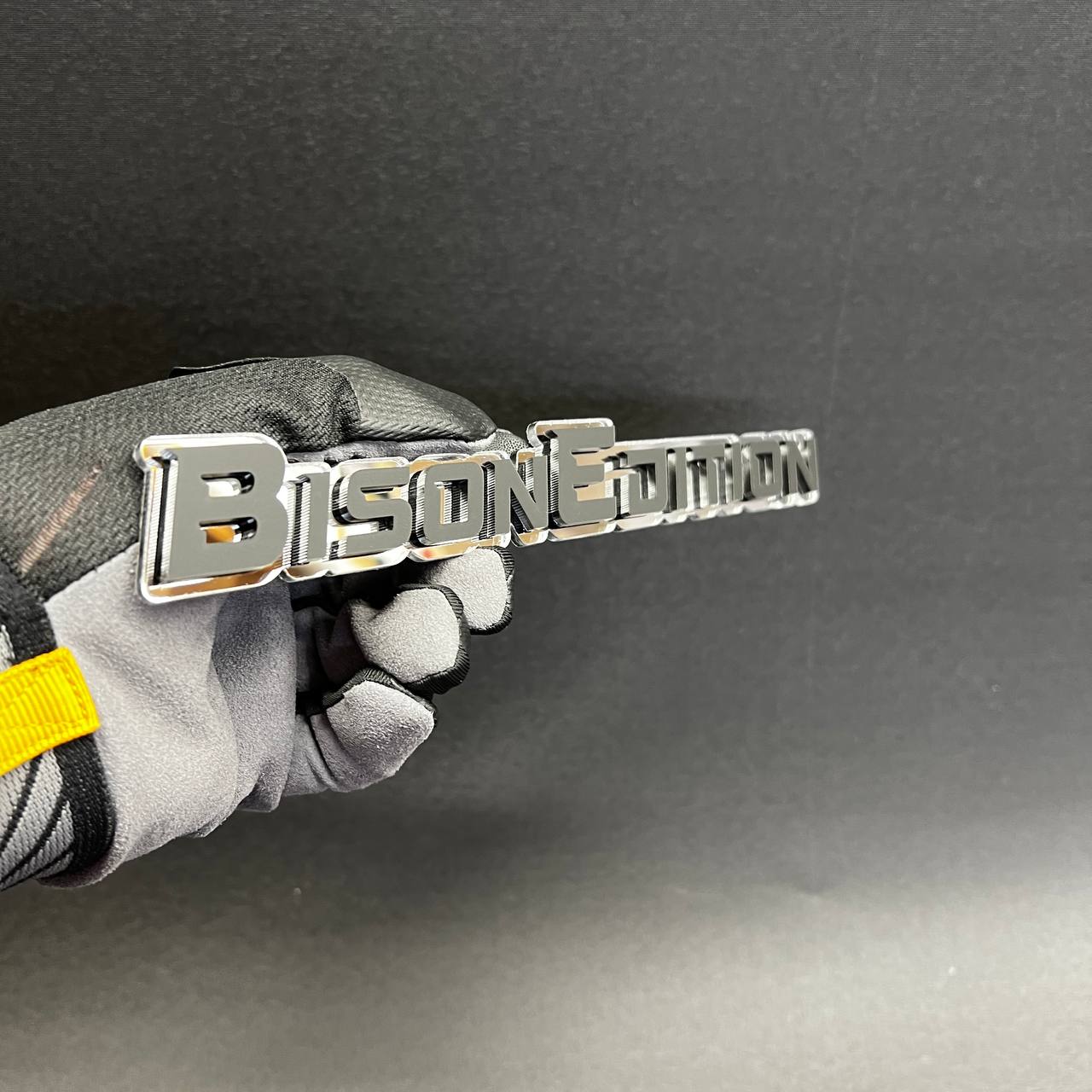 White and gold BISON EDITION SUV badge for exterior use